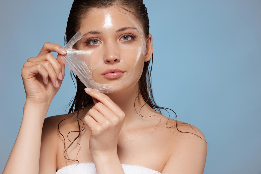 attractive woman removing moisturizing mask
