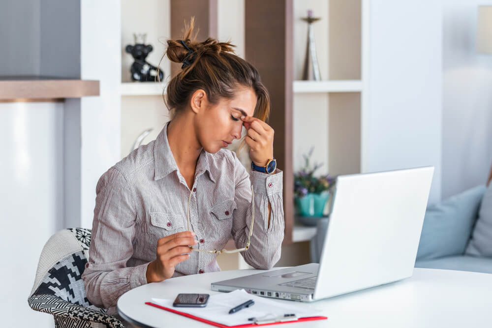 women working at office suffering from headache