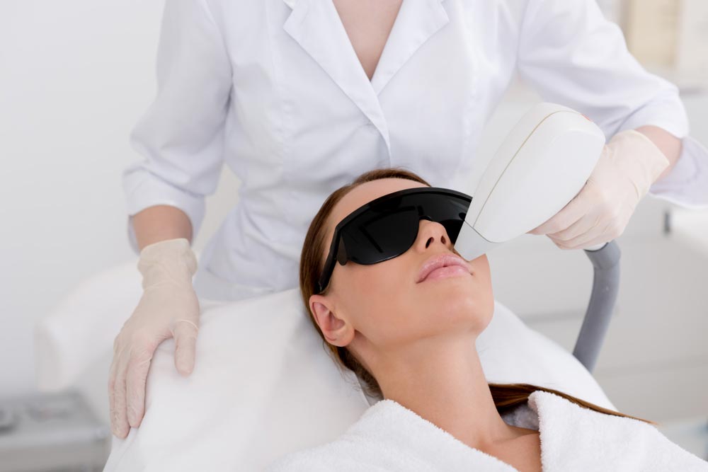 young woman receiving laser hair removal epilation