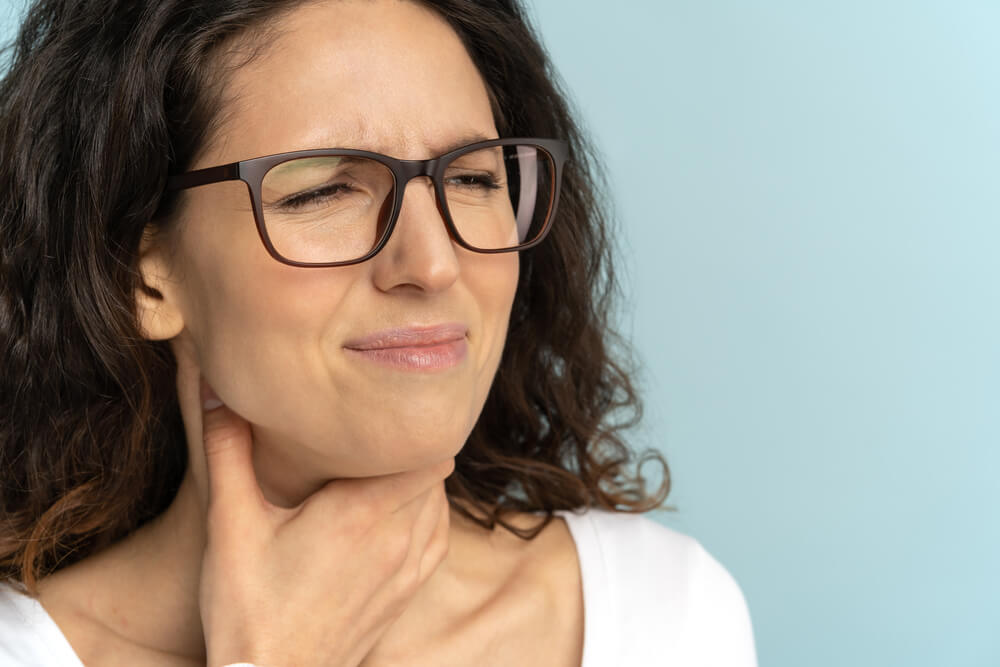 sick women suffering from painful swallowing and hoarseness