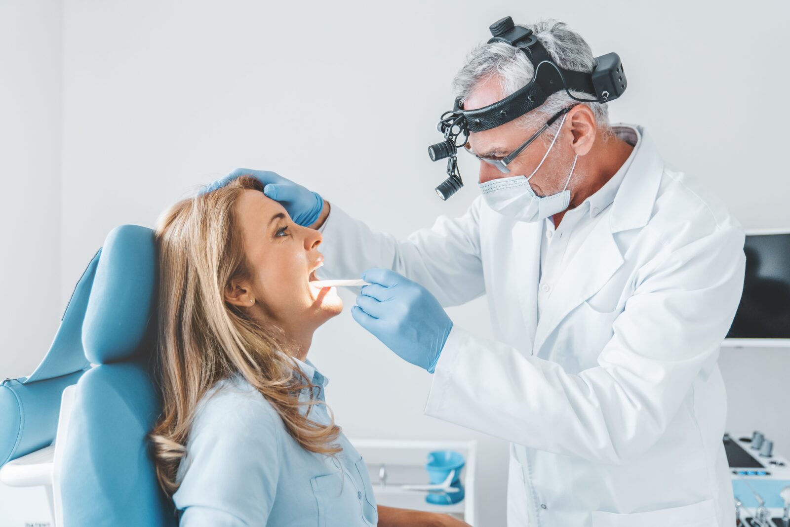 woman having her throat examined by doctor