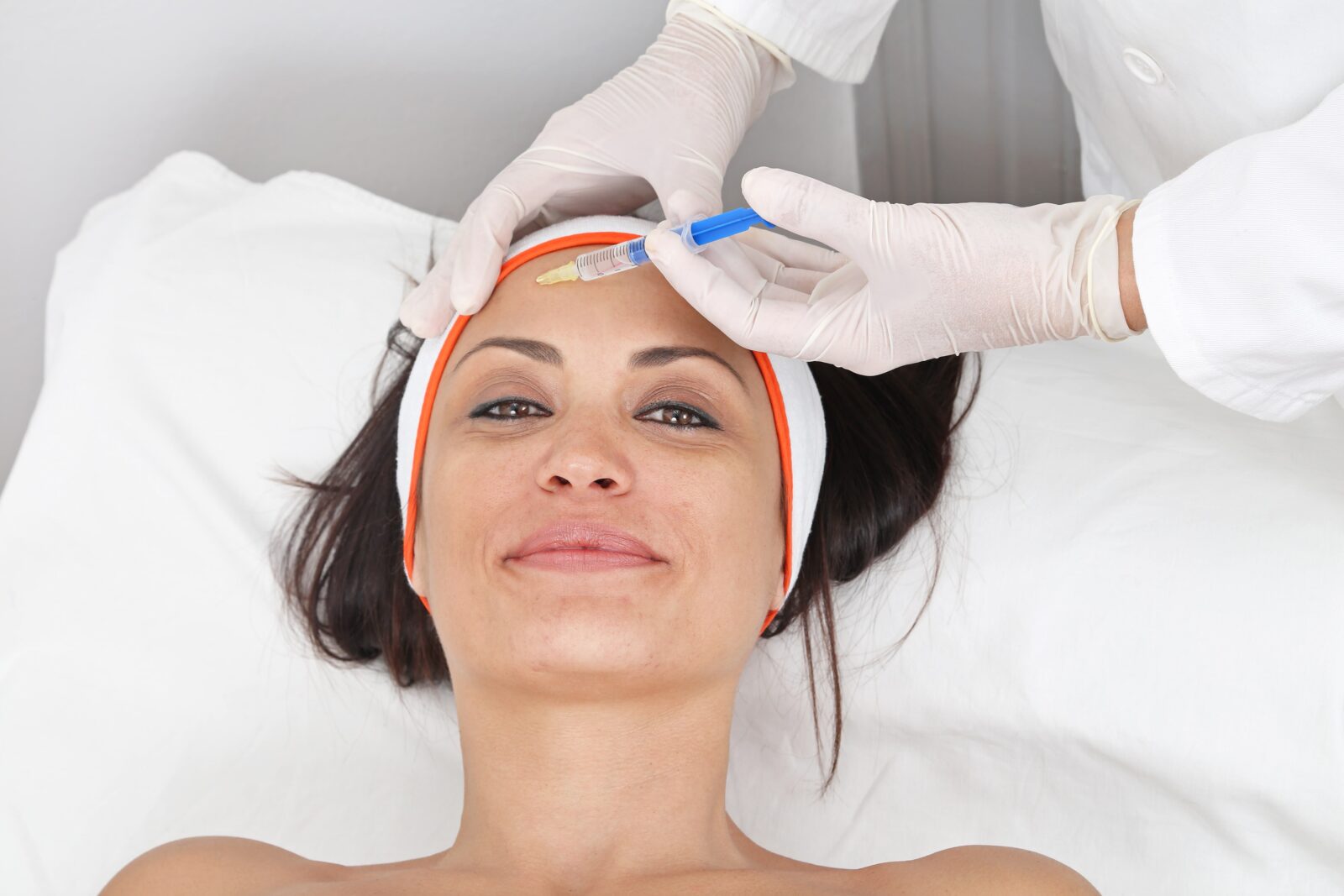 woman having dermal fillers injected into her forehead